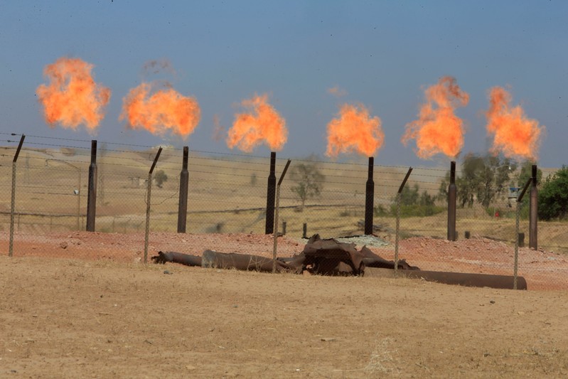 FILE PHOTO: Flames emerge from flare stacks at the oil fields in Dibis area on the outskirts of Kirkuk