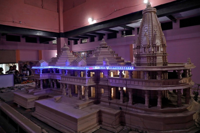 FILE PHOTO: People look at a model of a proposed Ram temple that Hindu groups want to build at a disputed religious site in Ayodhya