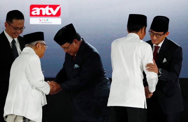 Indonesia's President Joko Widodo, his running mate Ma'ruf Amin greet presidential candidate Prabowo Subianto and his running mate Sandiago Uno before a debate in Jakarta, Indonesia