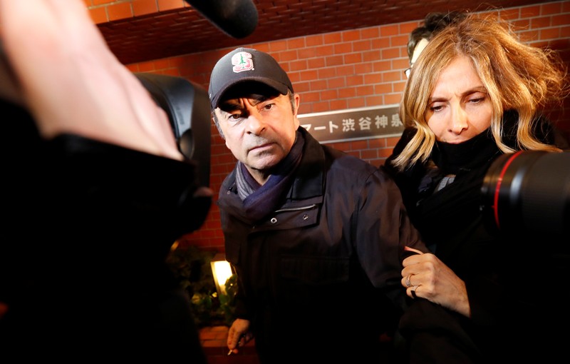 Former Nissan Motor Chairman Carlos Ghosn accompanied by his wife Carole Ghosn, arrives at his place of residence in Tokyo