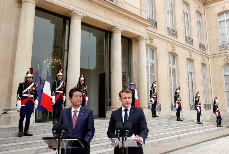 French President Emmanuel Macron and Japan's Prime Minister Shinzo Abe give a joint statement to the media at the Elysee Palace in Paris