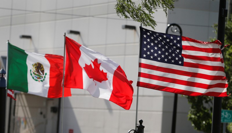 FILE PHOTO: Flags of the U.S., Canada and Mexico fly next to each other in Detroit, Michigan