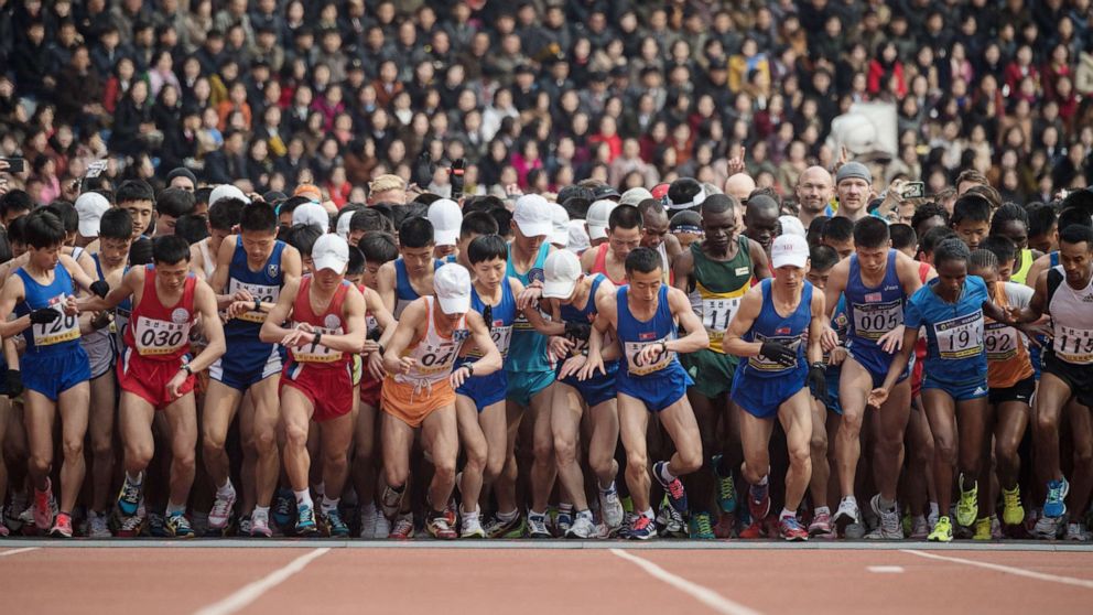 Competitors cross the start line of the the annual Pyongyang marathon at Kim Il Sung stadium in Pyongyang in this April 8, 2018 file photo.