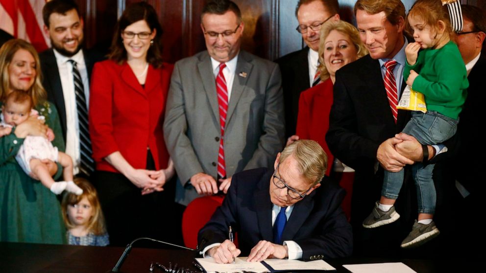 Gov. Mike DeWine signs a bill imposing one of the nation's toughest abortion restrictions, April 11, 2019 in Columbus, Ohio. DeWine's signature makes Ohio the fifth state to ban abortions after the first detectable fetal heartbeat. That can come as early as five or six weeks into pregnancy, before many women know they're pregnant.