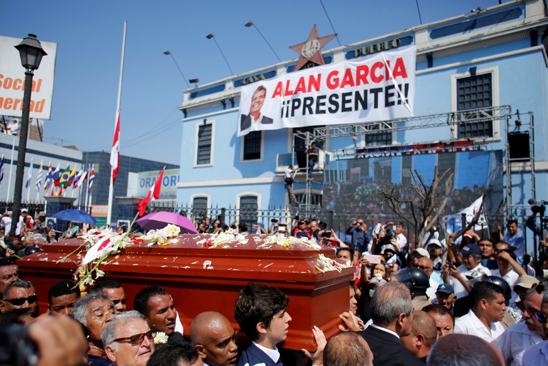 Friends and family carry the coffin with the remains of Peru's former President Alan Garcia during the last of three days of national mourning declared by President Martin Vizcarra, in Lima