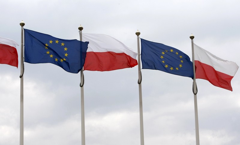 The flags of Poland and European Union flutter in front of the Polish parliament in Warsaw