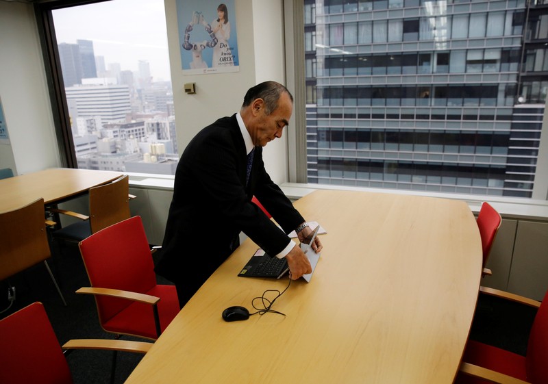 Yasuhiro Furuse, a senior adviser of corporate sales headquarters of Orix Corp., unfolds his laptop at a meeting room in Tokyo