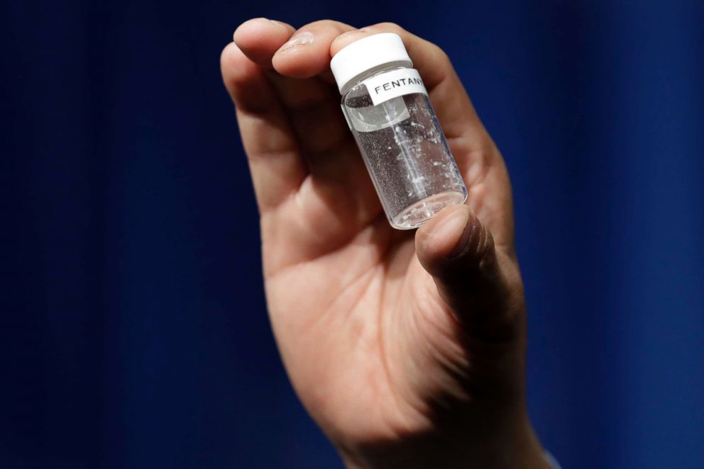 A person holds up an example of the amount of fentanyl that can be deadly after a news conference about deaths from fentanyl exposure, at DEA Headquarters in Arlington, Va., June 6, 2017.
