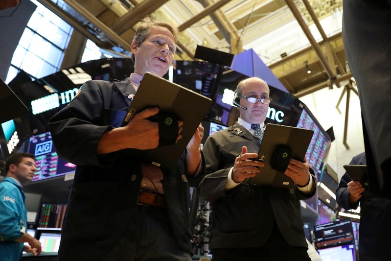 Traders work on the floor at the NYSE in New York