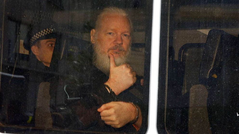 WikiLeaks founder Julian Assange is seen in a police van after was arrested by British police outside the Ecuadorian embassy in London, April 11, 2019.