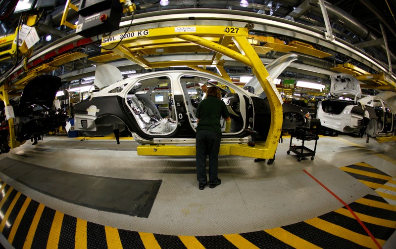 FILE PHOTO: Staff work on the Jaguar XJ production line at their Castle Bromwich Assembly Plant in Birmingham