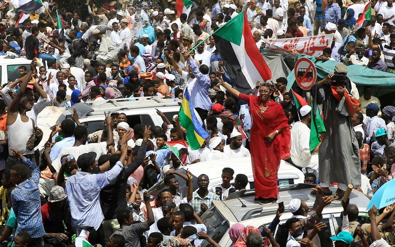 FILE PHOTO: Sudanese demonstrators protest against the army's announcement that President Omar al-Bashir would be replaced by a military-led transitional council, near Defence Ministry in Khartoum