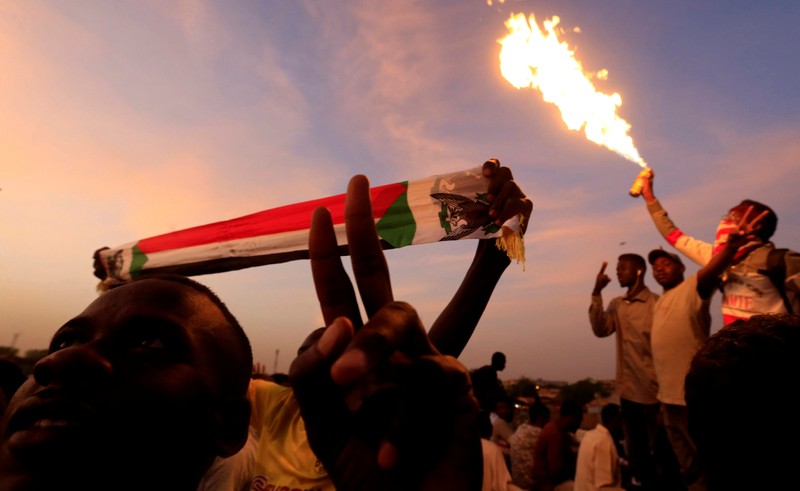 A Sudanese demonstrator gestures as he attends a sit-in protest outside the Defence Ministry in Khartoum