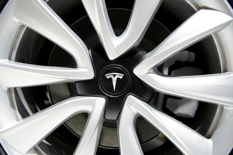 FILE PHOTO: Tesla logo is seen on a wheel rim during the media day for the Shanghai auto show in Shanghai
