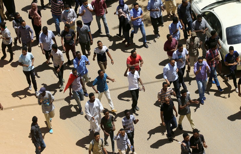 Sudanese demonstrators chant slogans during a protest demanding Sudanese President Omar Al-Bashir to step down in Khartoum