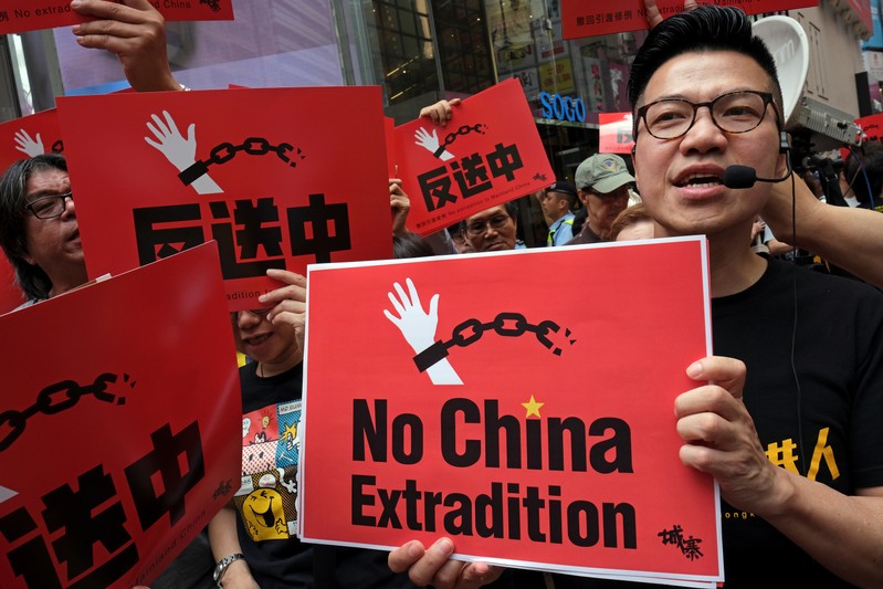 Demonstrators march during a protest to demand authorities scrap a proposed extradition bill with China, in Hong Kong