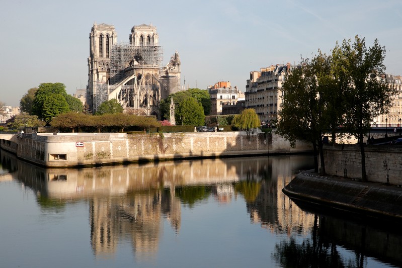 A view shows Notre-Dame Cathedral reflected on the River Seine after a massive fire devastated large parts of the gothic structure in Paris
