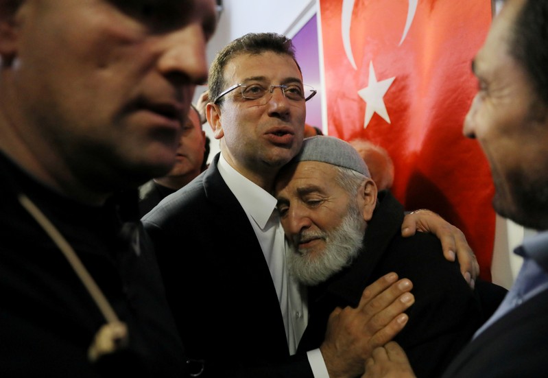 FILE PHOTO: Ekrem Imamoglu, main opposition CHP candidate for mayor of Istanbul, embraces his supporter at his election campaign office in Istanbul