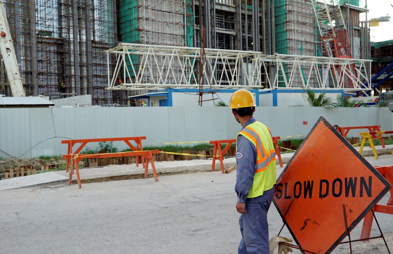 FILE PHOTO: A worker stands outside the construction site of the new Best Sunshine Live casino at Saipan, a U.S. South Pacific island