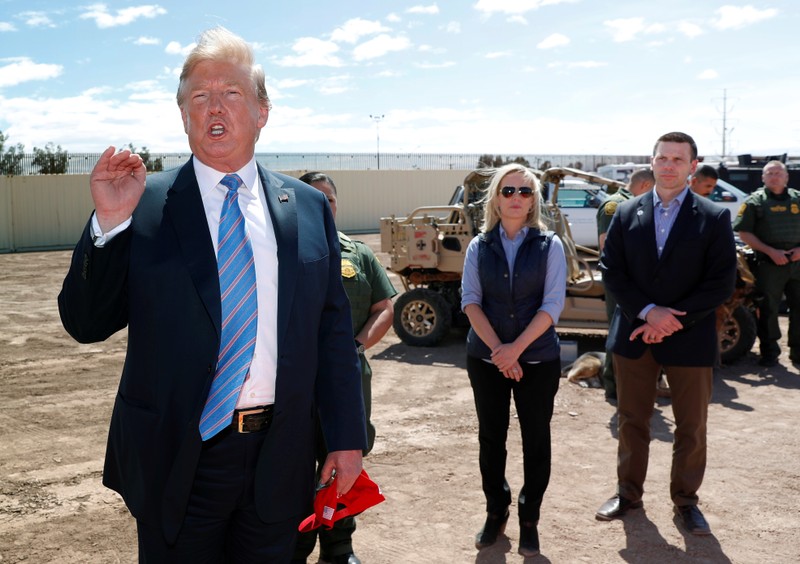 FILE PHOTO: Neilsen and McAleenan listen to Trump at border security tour in California