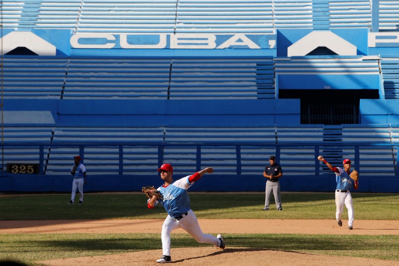 Cuba's national youth baseball pitcher Oscar Hernandez warms up before a friendly game against Japan at the Latinoamericano stadium in Havana