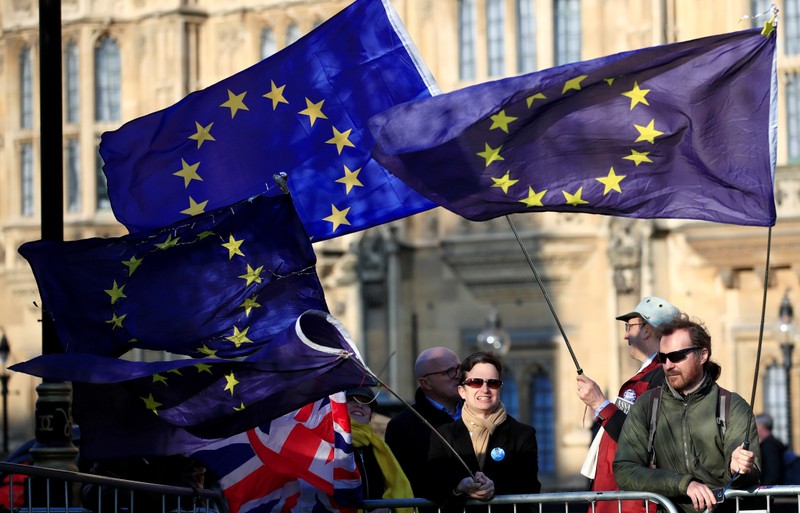 FILE PHOTO: Anti-Brexit protesters hold EU flags as they demonstrate outside the Houses of Parliament in London