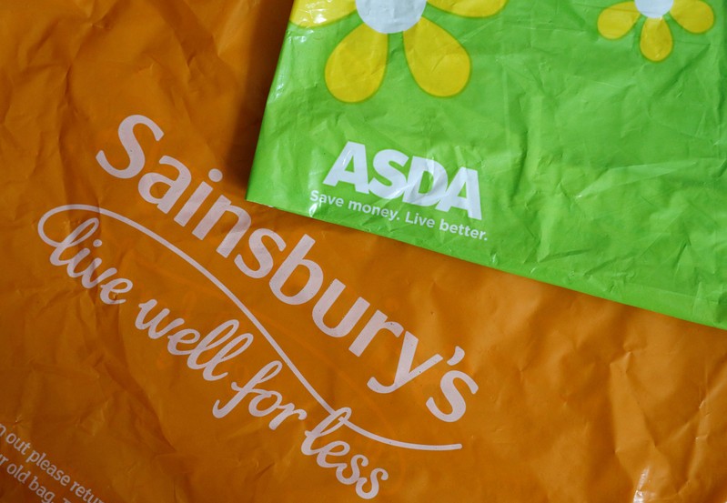 FILE PHOTO: Shopping bags from Asda and Sainsbury's are seen in Manchester.