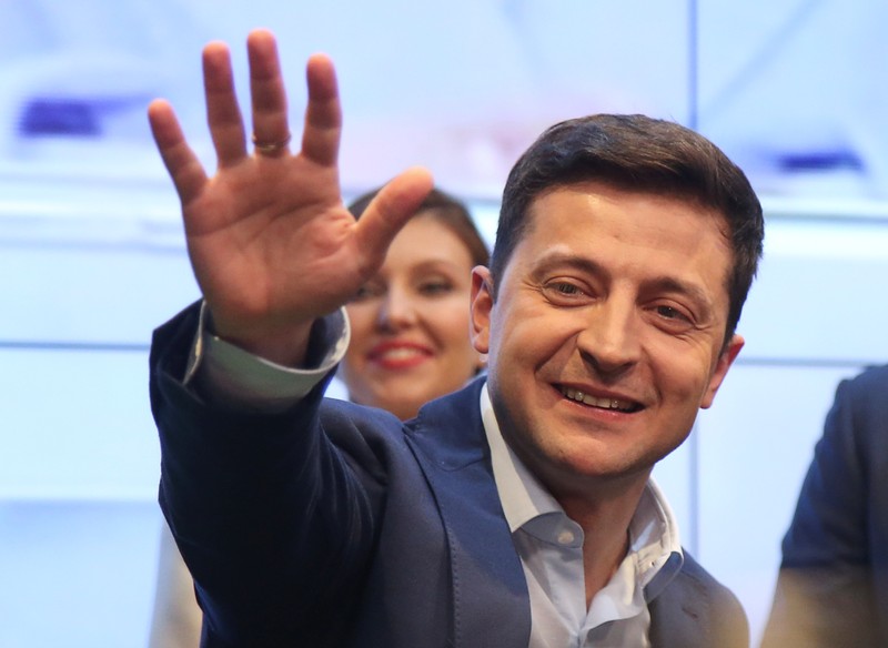 FILE PHOTO: Candidate Zelenskiy waves to supporters following the announcement of an exit poll in Ukraine's presidential election in Kiev