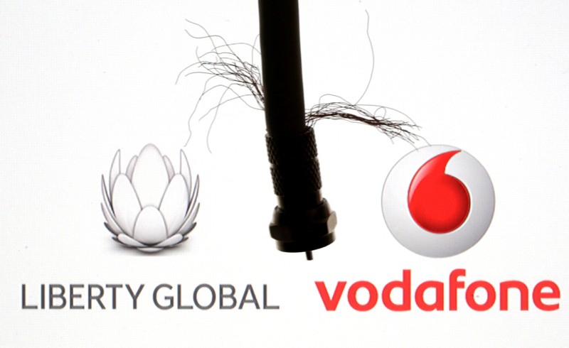 FILE PHOTO: Coaxial TV Cable is seen in front of Vodafone and Liberty Global logos in this illustration