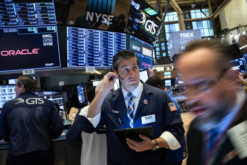 Traders work on the floor at the NYSE in New York