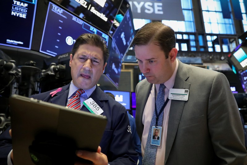 A trader speaks to a floor official on the floor at the NYSE in New York