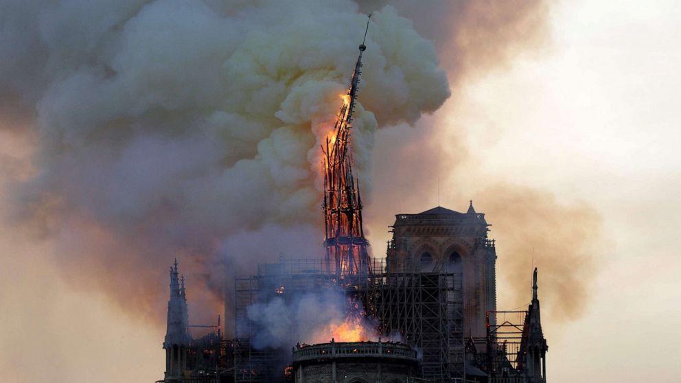 The steeple of the landmark Notre-Dame Cathedral collapses as the cathedral is engulfed in flames in Paris, April 15, 2019.