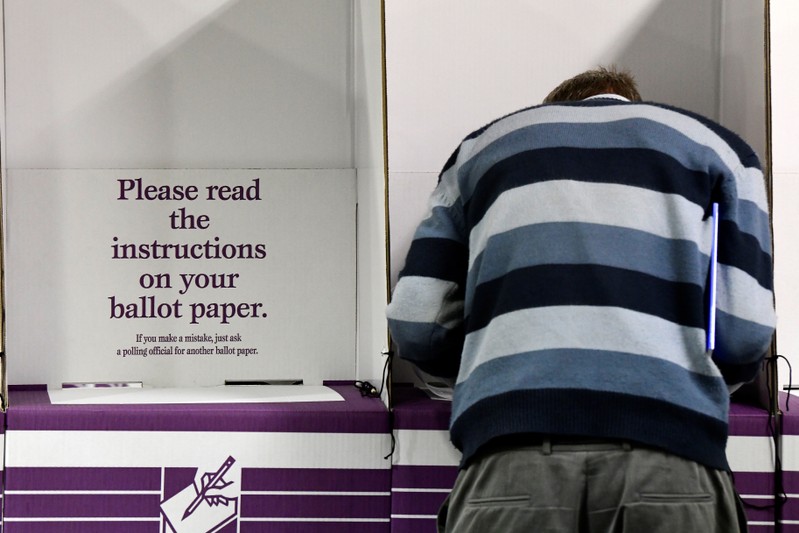 A voter participates in early voting at a pre-polling booth at Central Station, Sydney