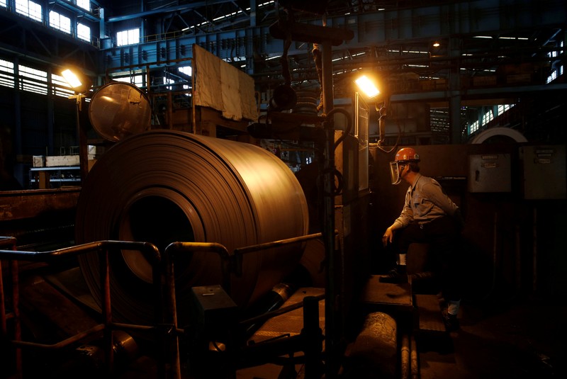FILE PHOTO: A worker inspects a roll of steel inside the China Steel Corporation factory in Kaohsiung
