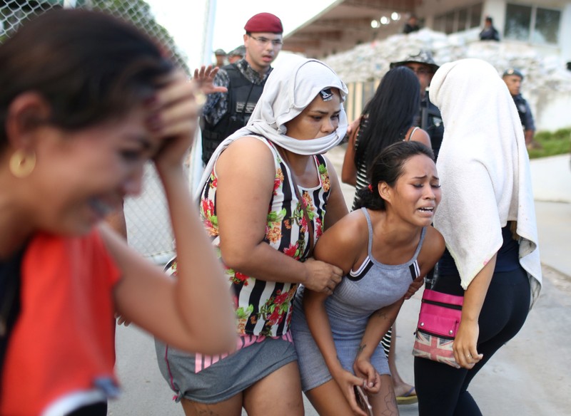 Relatives of inmates react in front of a prison complex in the Brazilian state of Amazonas after prisoners were found strangled to death in four separate jails, according to the penitentiary department in Manaus