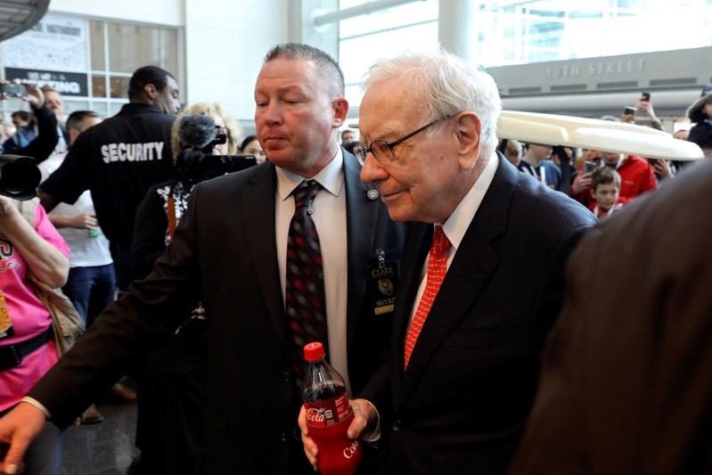 Berkshire Hathaway Chairman Warren Buffett walks past a crowd at the annual Berkshire shareholder shopping day in Omaha