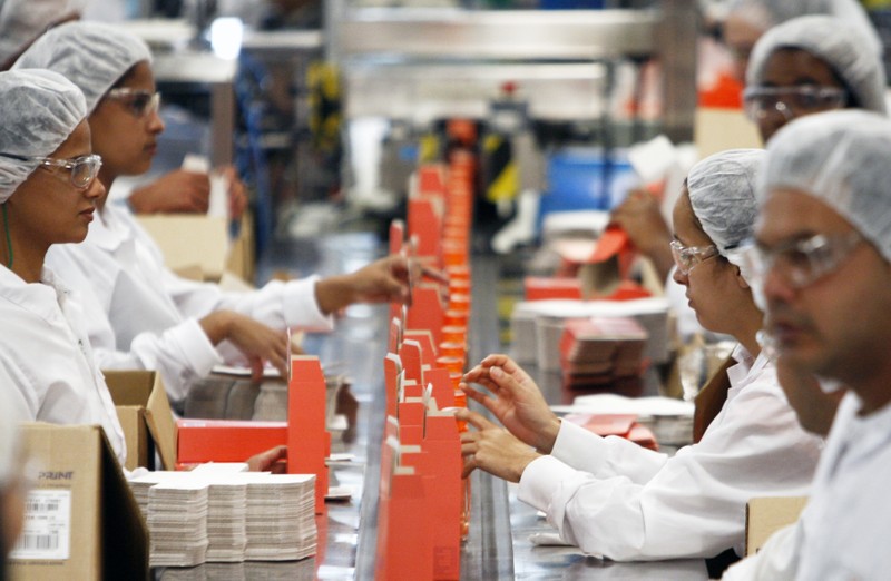 Workers pack cosmetic products into boxes at Natura's factory in Cajamar