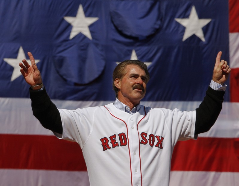Former Red Sox player Buckner acknowledges cheers from crowd before throwing out ceremonial first pitch at MLB baseball game between Red Sox and Tigers in Boston