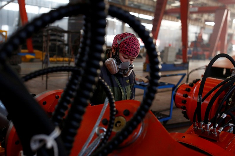 FILE PHOTO: A woman works in the Tianye Tolian Heavy Industry Co. factory in Qinhuangdao