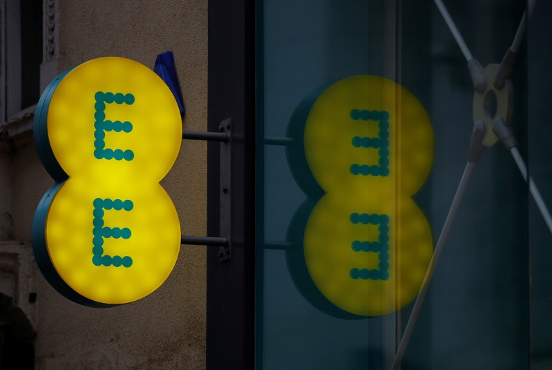FILE PHOTO: Signage is seen outside an EE mobile phone shop in Manchester