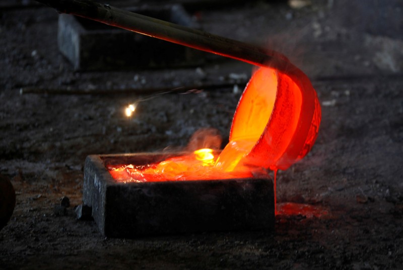 FILE PHOTO: Molten rare earth metal Lanthanum is poured into a mold at a smelting workshop near the town of Damao in China's Inner Mongolia Autonomous Region
