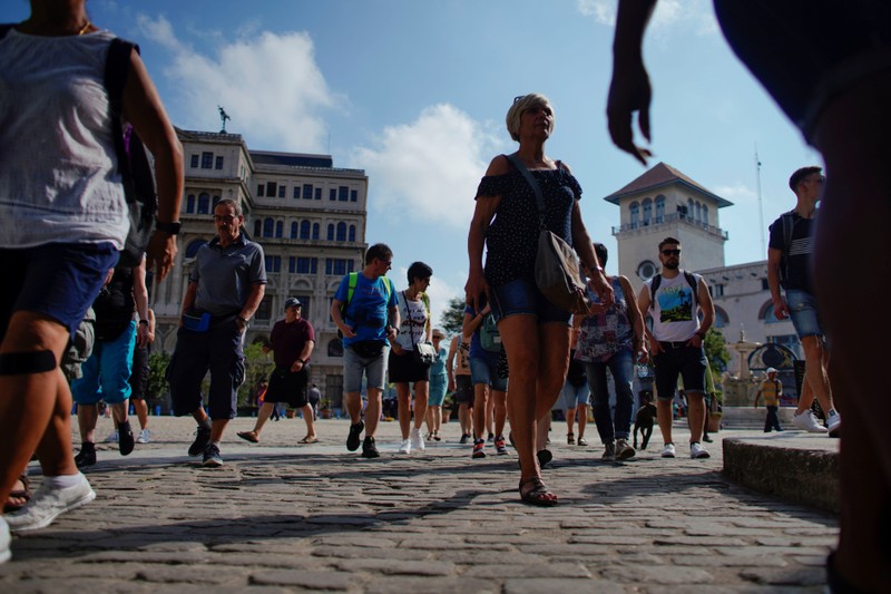 Tourists walk in Havana