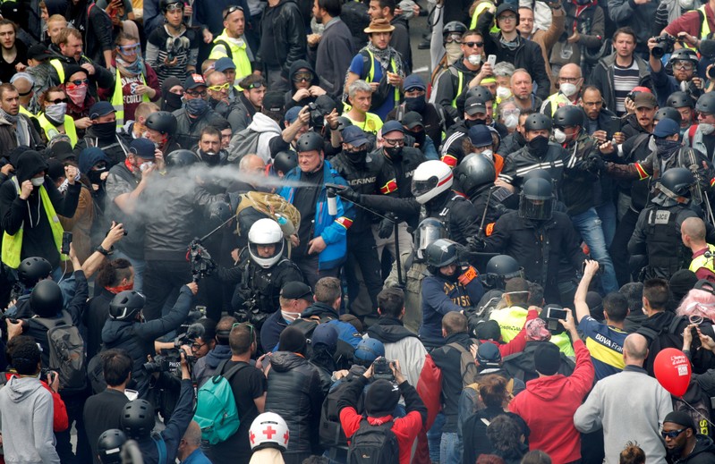 FILE PHOTO: French police apprehend protesters during the May Day march involving French unions and yellow vest protesters in Paris