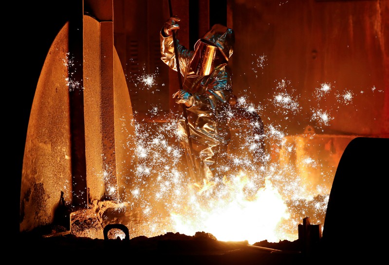 FILE PHOTO: A steel worker of Germany's industrial conglomerate ThyssenKrupp AG takes a sample of raw iron from a blast furnace at Europe's largest steel factory in Duisburg
