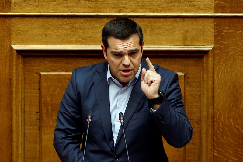 Greek PM Alexis Tsipras addresses lawmakers during a parliamentary session before a vote on German World War II reparations in Athens