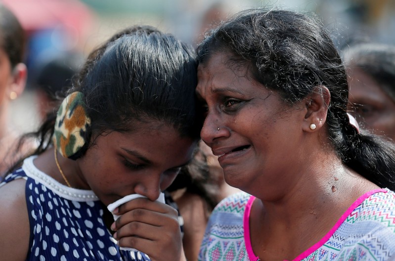 Devotees cry while praying in front of St Anthony's church in Colombo