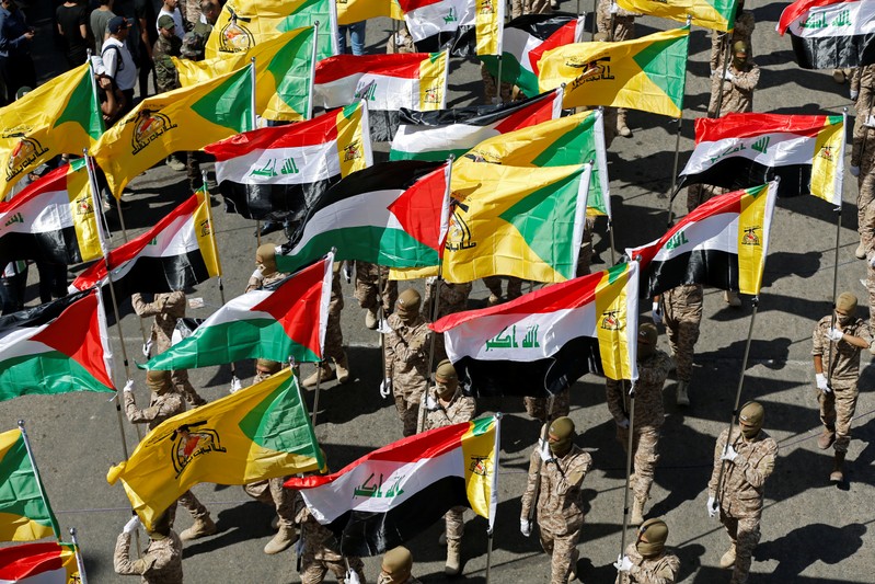 Iraqi Shi'ite Muslims march during a parade marking the annual al-Quds Day (Jerusalem Day) on the last Friday of the Muslim holy month of Ramadan in Baghdad