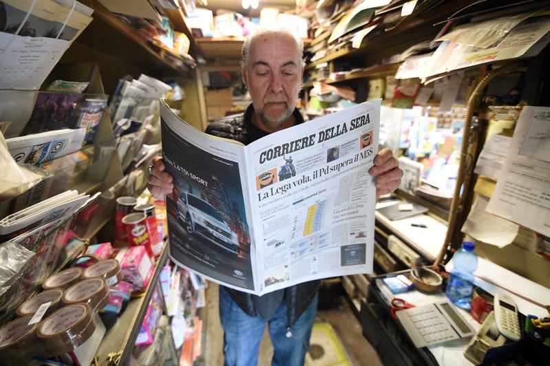 A man reads a newspaper with news of the rise of the far-right League party in Sunday's European parliamentary election in Milan