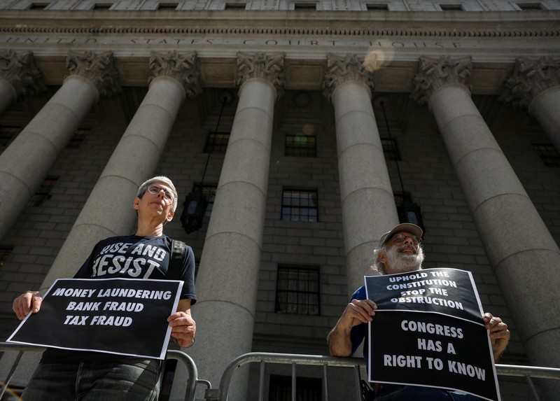 Protesters stand outside the Manhattan Federal Courthouse in New York
