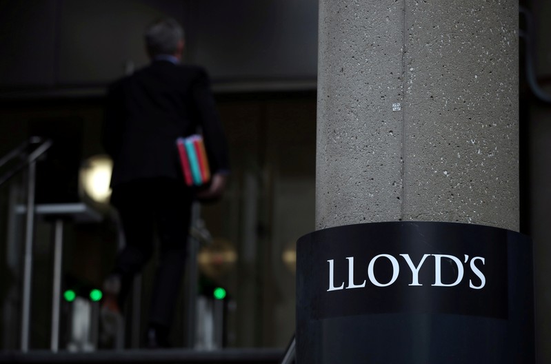 FILE PHOTO: A nan enters the Lloyd's of London building in the City of London financial district